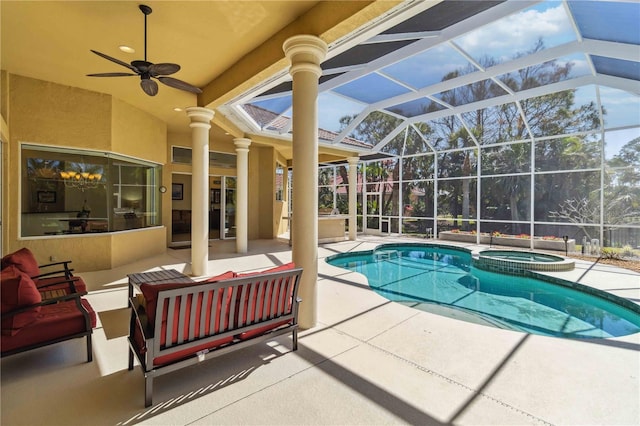 view of pool with glass enclosure, a patio, an outdoor living space, a pool with connected hot tub, and ceiling fan