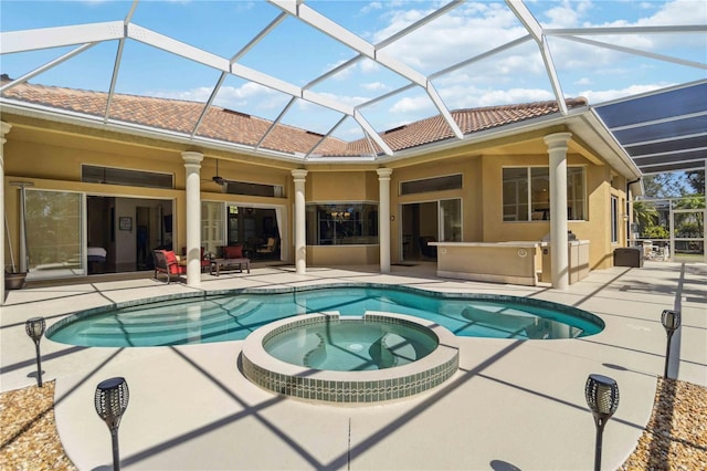 view of swimming pool with a patio area, a pool with connected hot tub, and ceiling fan