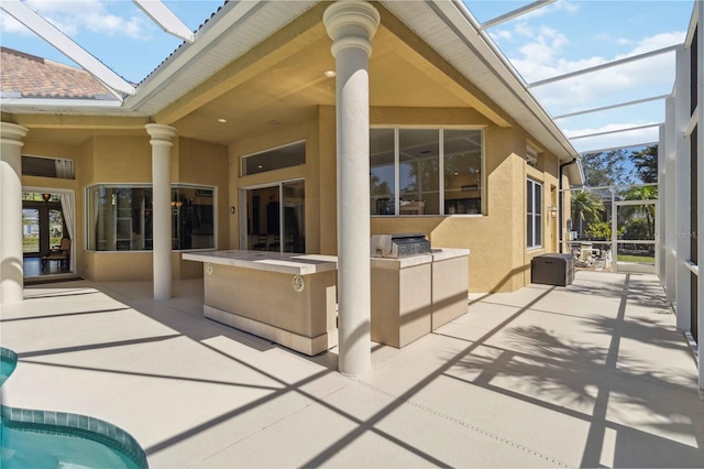 exterior space with an outdoor kitchen, a patio, and stucco siding