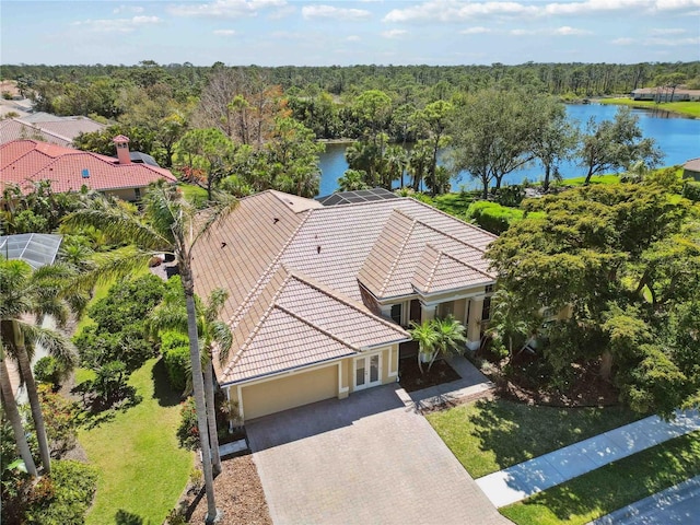 bird's eye view featuring a forest view and a water view