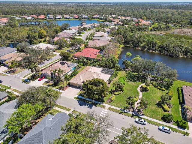 bird's eye view with a water view and a residential view