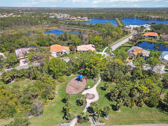 drone / aerial view featuring a view of trees and a water view