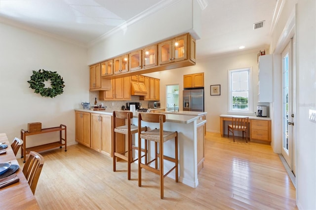 kitchen featuring light wood-style floors, visible vents, crown molding, and stainless steel refrigerator with ice dispenser