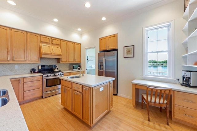 kitchen featuring a kitchen island with sink, a sink, tasteful backsplash, stainless steel appliances, and custom exhaust hood