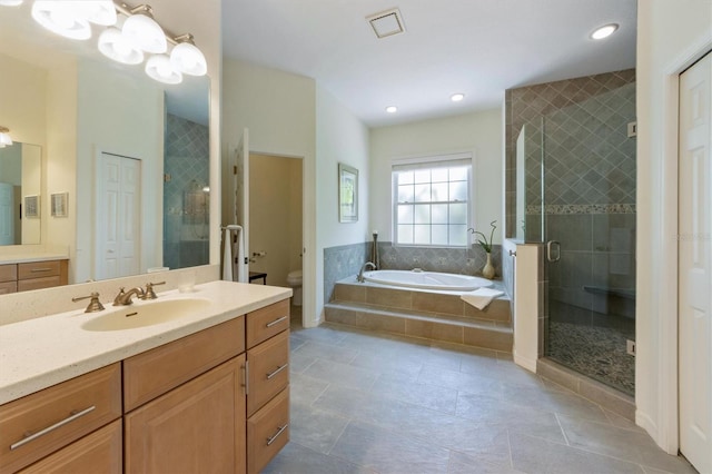 bathroom with a garden tub, toilet, a stall shower, tile patterned flooring, and vanity