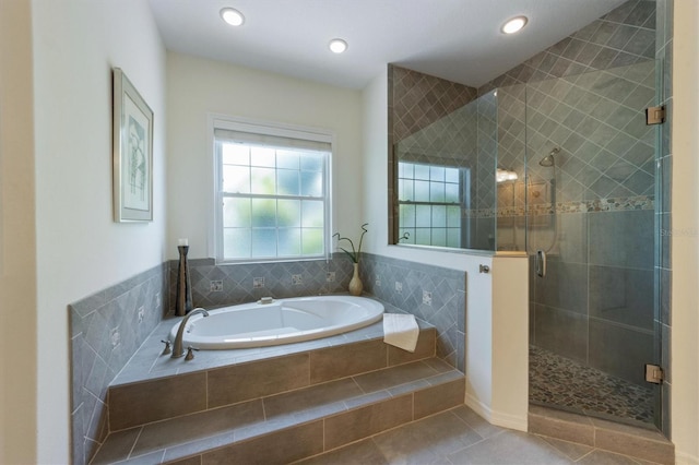 bathroom with a bath, recessed lighting, tile patterned floors, and a stall shower