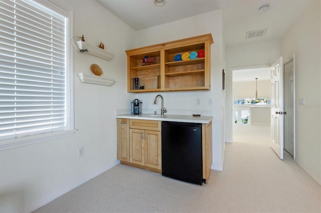 bar with visible vents, light colored carpet, fridge, and a sink