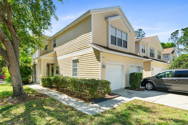 view of home's exterior featuring concrete driveway and a garage