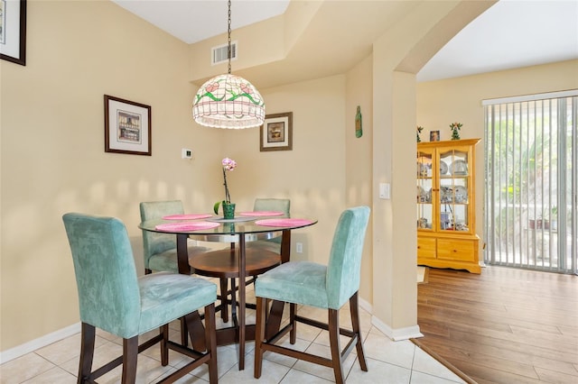 dining space featuring light tile patterned flooring, baseboards, and visible vents