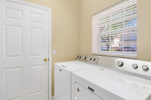 clothes washing area with laundry area and washer and dryer