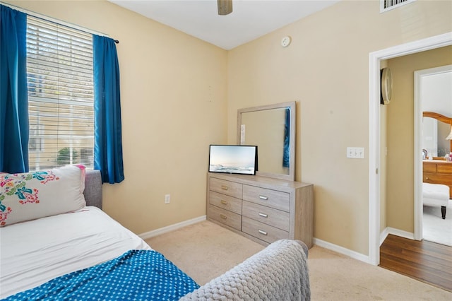 carpeted bedroom with a ceiling fan and baseboards