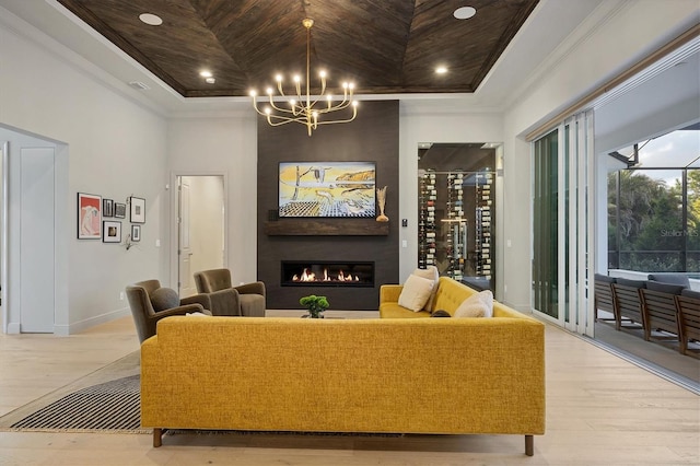 living room with crown molding, a fireplace, and a raised ceiling