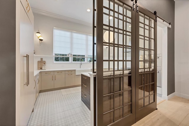 bathroom featuring a sink, baseboards, and ornamental molding