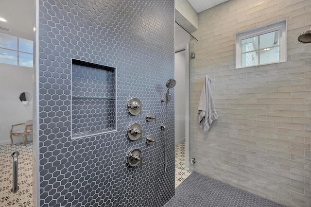 bathroom featuring tile patterned floors and tiled shower