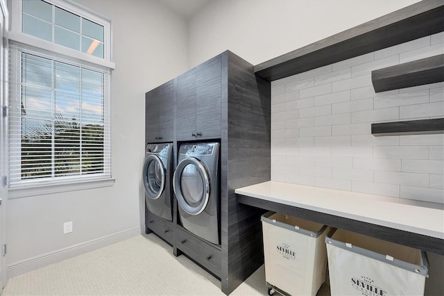 clothes washing area with light carpet, laundry area, baseboards, and separate washer and dryer