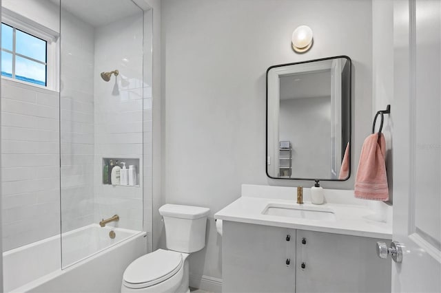 bathroom with baseboards, vanity, washtub / shower combination, and toilet