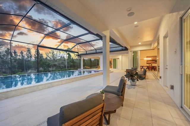 exterior space featuring glass enclosure and an infinity pool