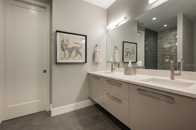 bathroom with tile patterned floors, double vanity, a tile shower, and a sink