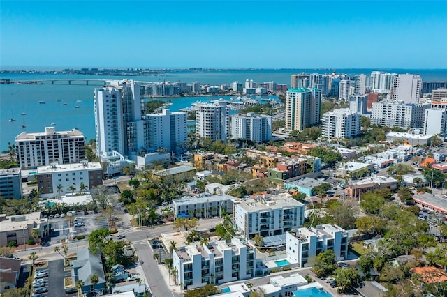 birds eye view of property featuring a city view and a water view