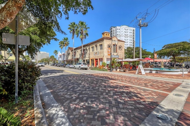 view of street with curbs, street lighting, and sidewalks