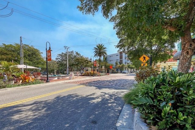 view of street featuring traffic signs and curbs