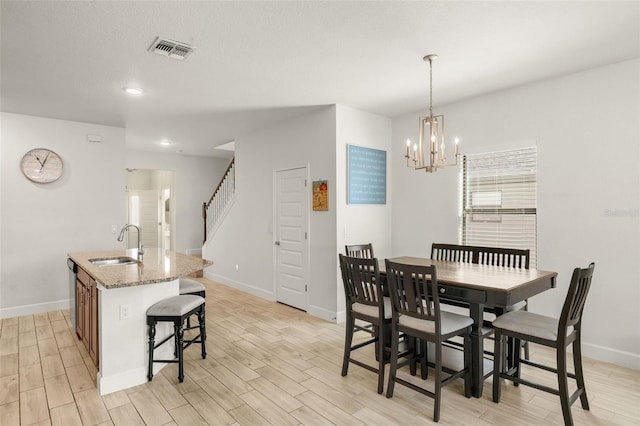 dining space with visible vents, stairway, baseboards, and light wood-style floors