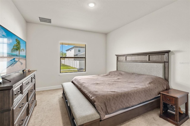 bedroom featuring visible vents, baseboards, and light colored carpet