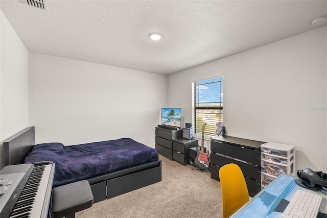 carpeted bedroom with visible vents and a textured ceiling