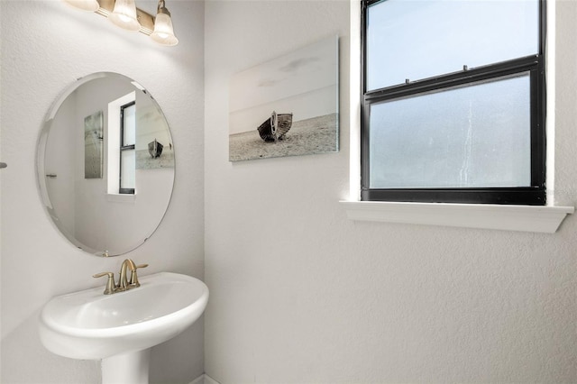 bathroom featuring a wealth of natural light and a sink