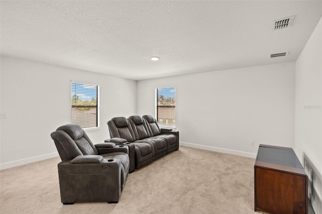 living area with a wealth of natural light, visible vents, and light carpet