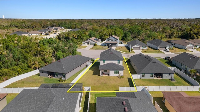 birds eye view of property with a wooded view and a residential view