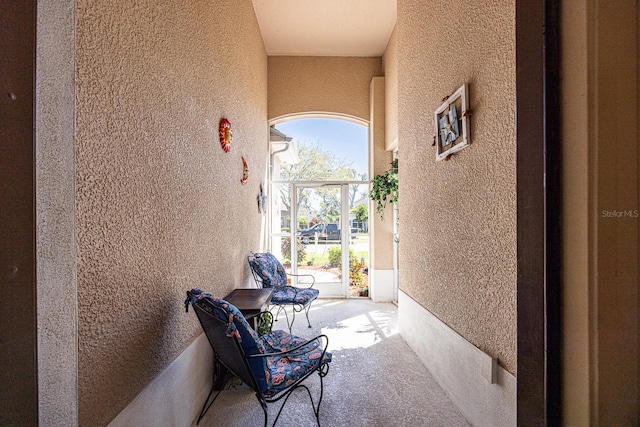 view of patio featuring glass enclosure