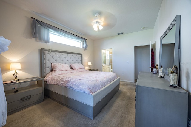 carpeted bedroom featuring connected bathroom, baseboards, visible vents, and a ceiling fan