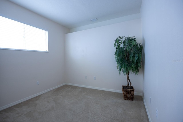 carpeted spare room with baseboards