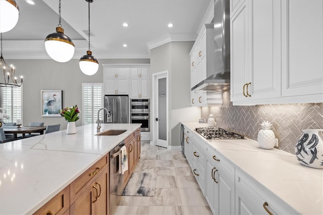 kitchen featuring a sink, stainless steel appliances, wall chimney exhaust hood, and ornamental molding