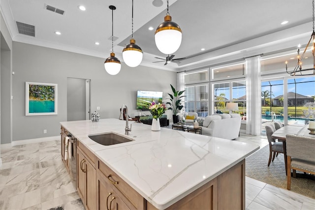 kitchen featuring crown molding, open floor plan, visible vents, and a sink