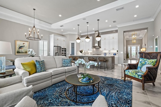 living area with visible vents, a tray ceiling, recessed lighting, crown molding, and a chandelier