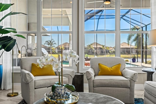 living area featuring a high ceiling and ceiling fan