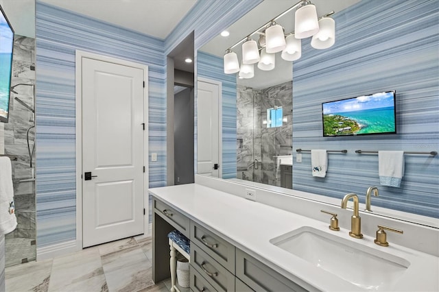 full bathroom featuring wallpapered walls, vanity, marble finish floor, and a tile shower