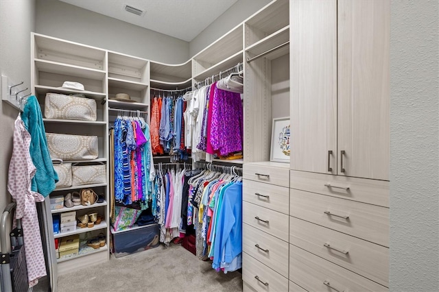 spacious closet featuring visible vents and carpet