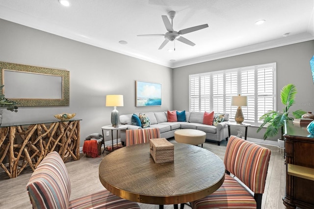 interior space with light wood-style floors, baseboards, crown molding, and ceiling fan