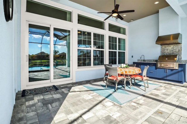 view of patio / terrace featuring grilling area, an outdoor kitchen, outdoor dining area, and a ceiling fan