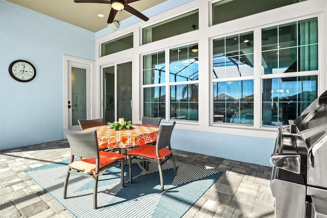 view of patio featuring outdoor dining area and a ceiling fan