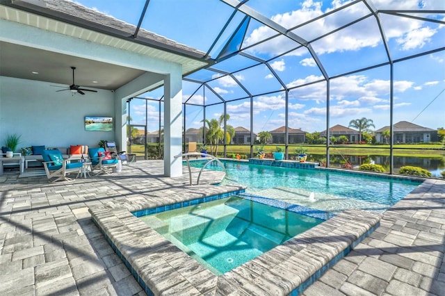 view of pool featuring ceiling fan, a patio, a pool with connected hot tub, and a lanai