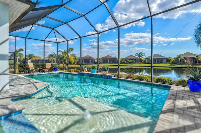 outdoor pool with a lanai, a patio area, and a water view