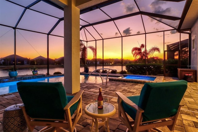 patio terrace at dusk with an outdoor pool, glass enclosure, and an in ground hot tub