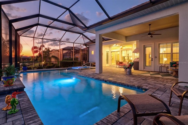 outdoor pool featuring a lanai, a patio area, and ceiling fan