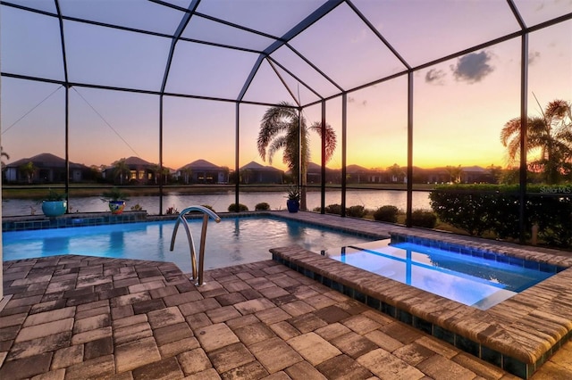 view of swimming pool with glass enclosure, a patio, and a pool with connected hot tub