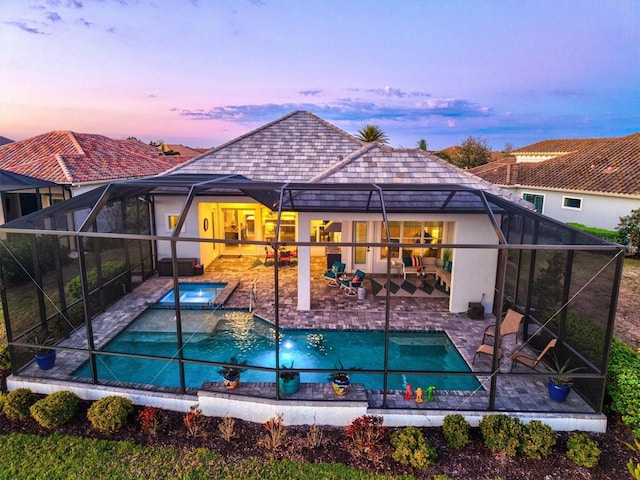 outdoor pool with a patio and a lanai