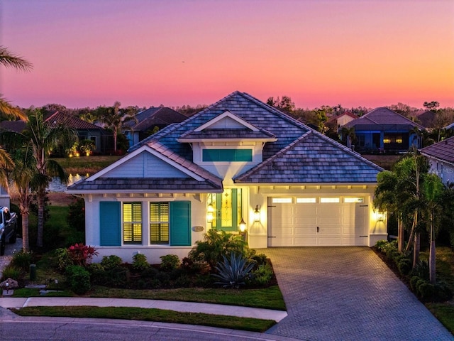 view of front of house featuring an attached garage, driveway, and stucco siding